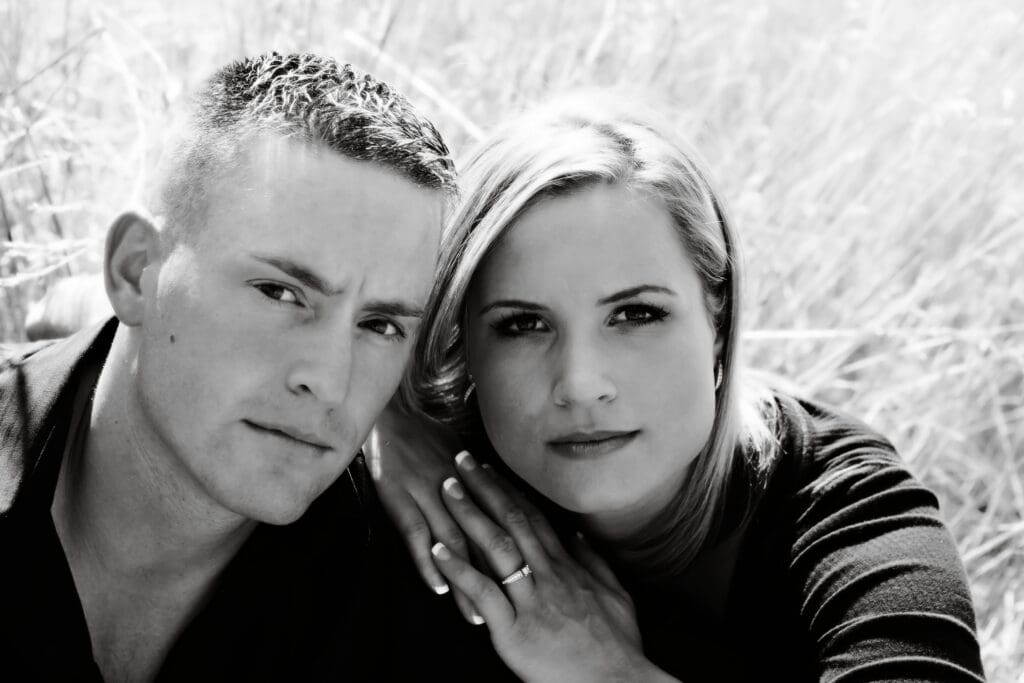 Engaged couple cuddling outdoors during a romantic engagement photography session by Tobi Rose Photography
