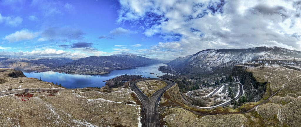 Winter aerial drone view of snow-covered Rowena Crest overlooking the Columbia River and Columbia River Gorge near Mosier, Oregon, photographed by Tobi Rose Photography.