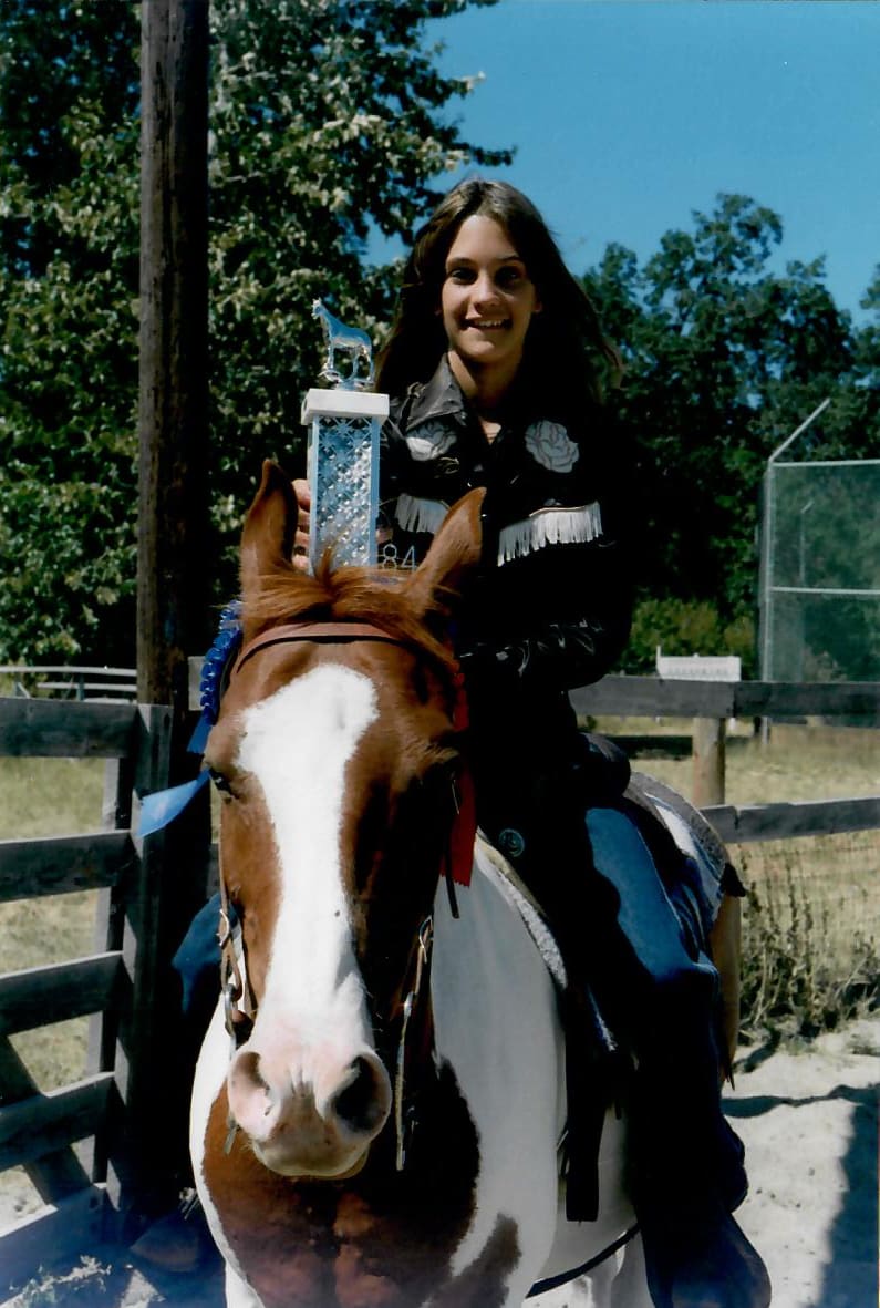 Tobi Rose Rabaliati on her horse Shadow with a 1984 horse show trophy at the Underwood horse arena in Washington