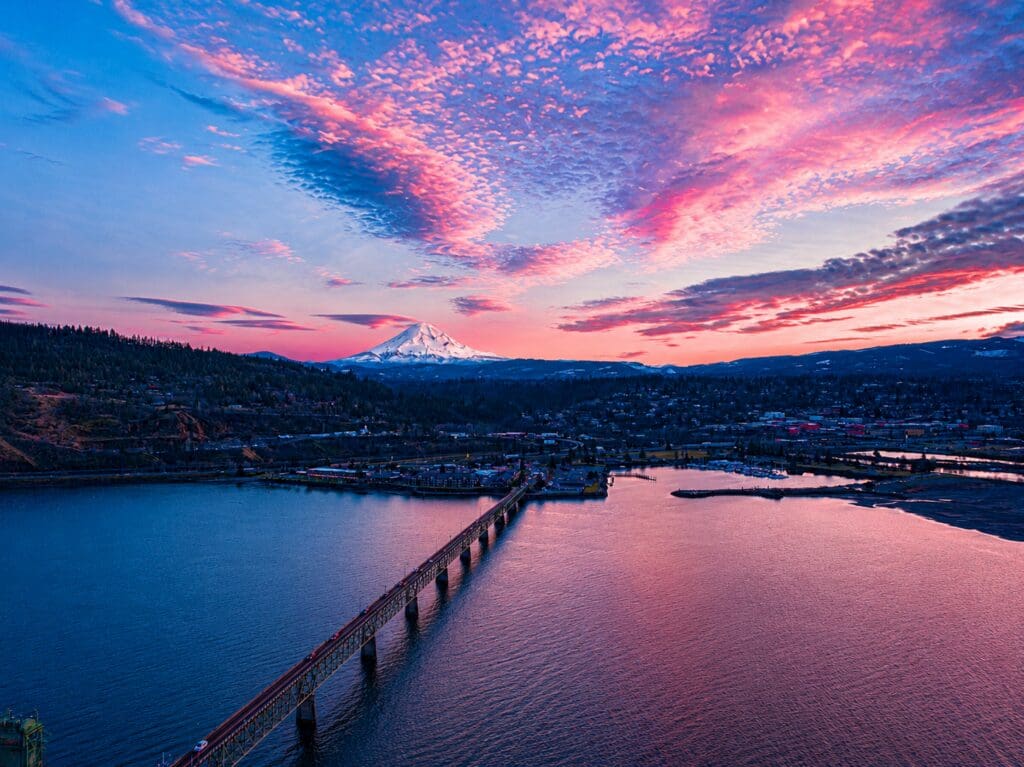Drone photograph of Mt. Hood and the Hood River–White Salmon Bridge at sunset over the Columbia River, photographed by Tobi Rose Photography.