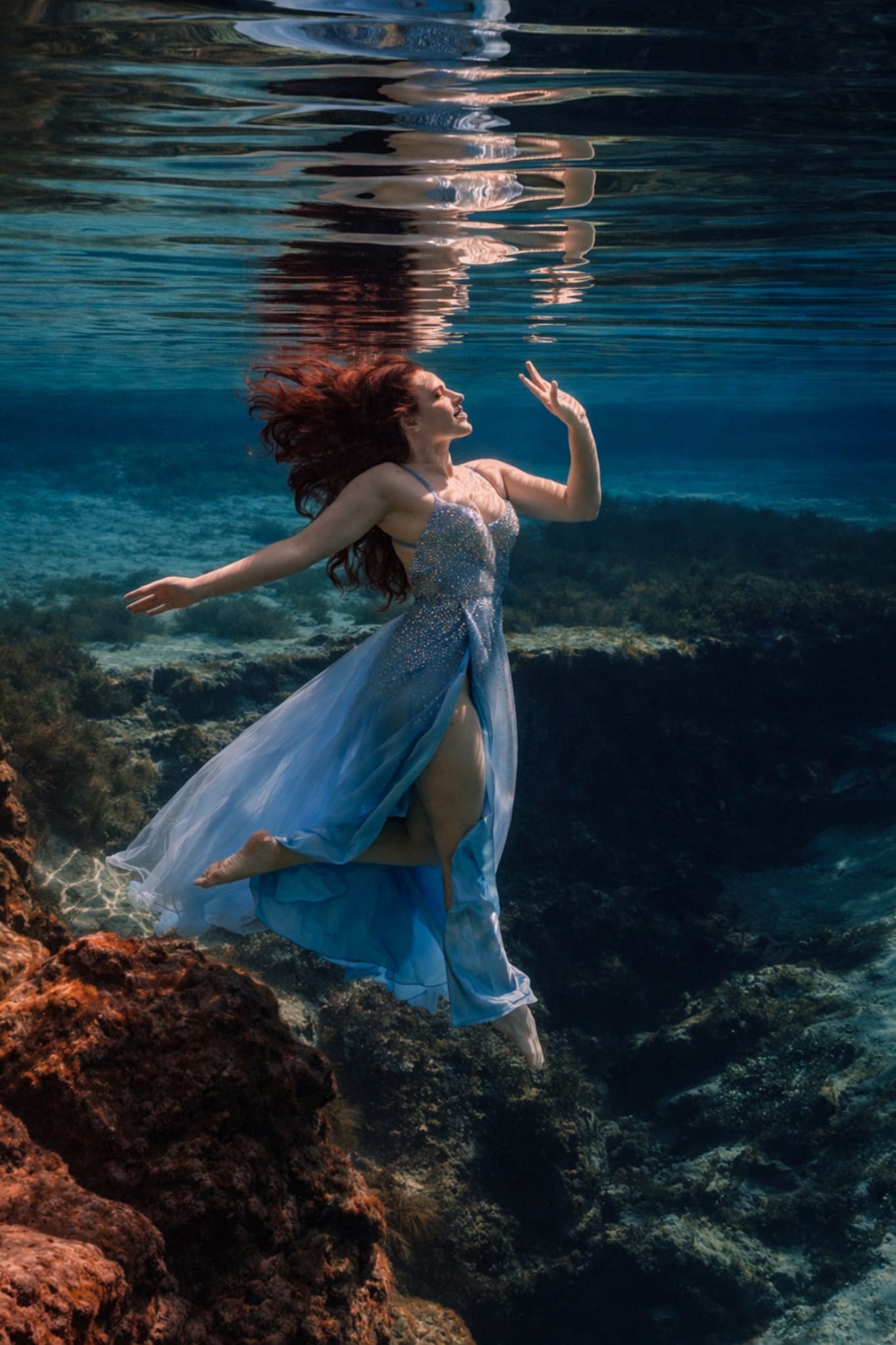 Woman in a flowing blue dress photographed underwater at Gilchrist Blue Springs in Florida by Tobi Rose Photography, Hood River, Oregon underwater photographer.