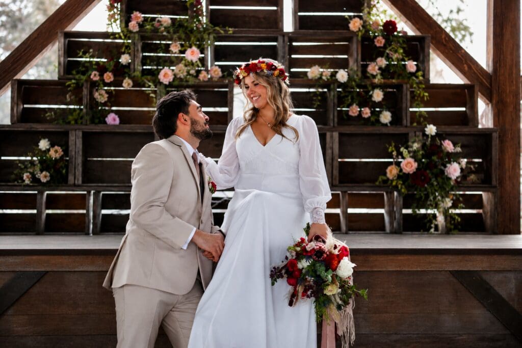 Bride and groom smiling at each other inside Tin Roof Barn during a winter wedding in the Columbia River Gorge near White Salmon, Washington, photographed by Tobi Rose Photography