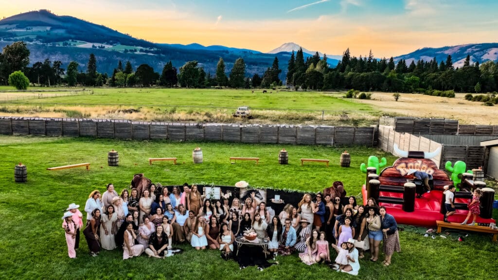Aerial drone photograph of the women gathered at Letty’s 50th birthday party with Mount Adams in the background at sunset in Hood River, Oregon, by Tobi Rose Photography.