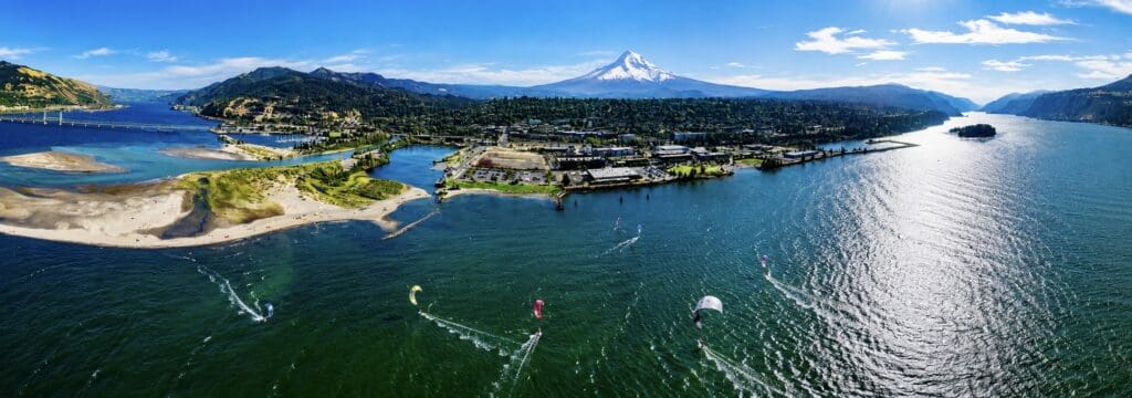 Aerial drone photograph of windsurfers on the Columbia River in Hood River, Oregon, surrounded by the Columbia River Gorge, photographed by Tobi Rose Photography.