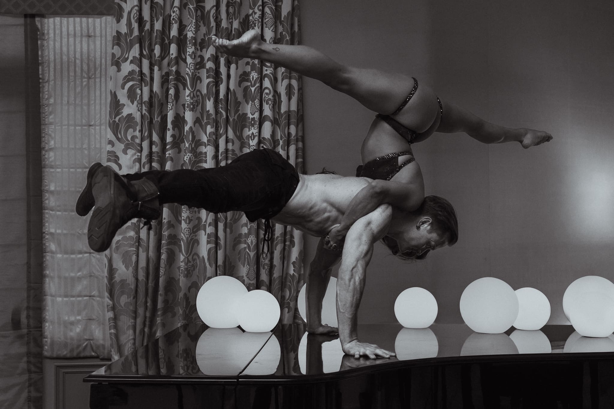 Holland Lohse and Sienna Martinez performing an acrobatic balance during a WPPI photography workshop in Las Vegas