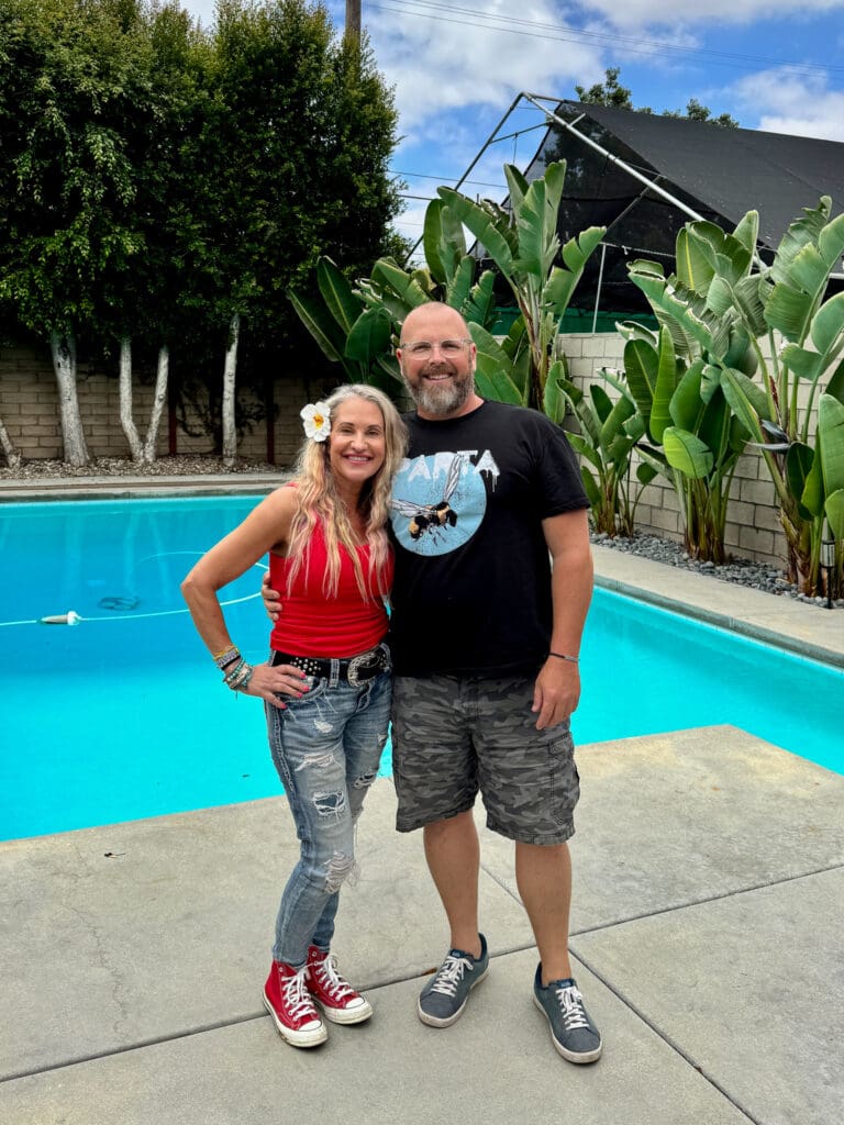 Tobi Rose Rabaliati with underwater photographer Brett Stanley standing beside his pool during his underwater photography workshop in Long Beach, California